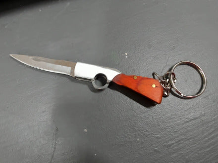 Red-ish gunshaped keychain knife