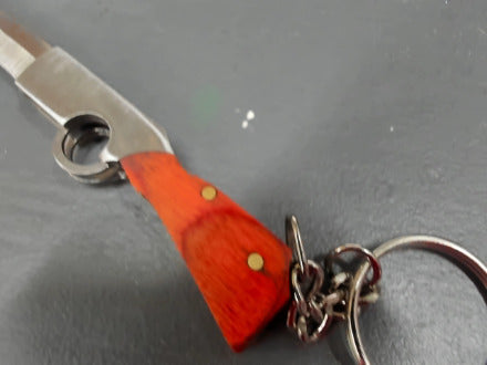 Red-ish gunshaped keychain knife